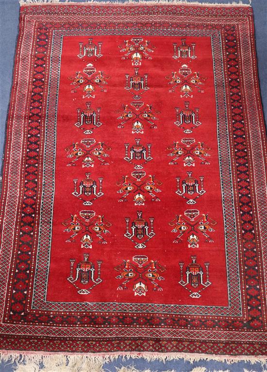 A Pakistan burgundy ground geometric rug 160 x 113cm